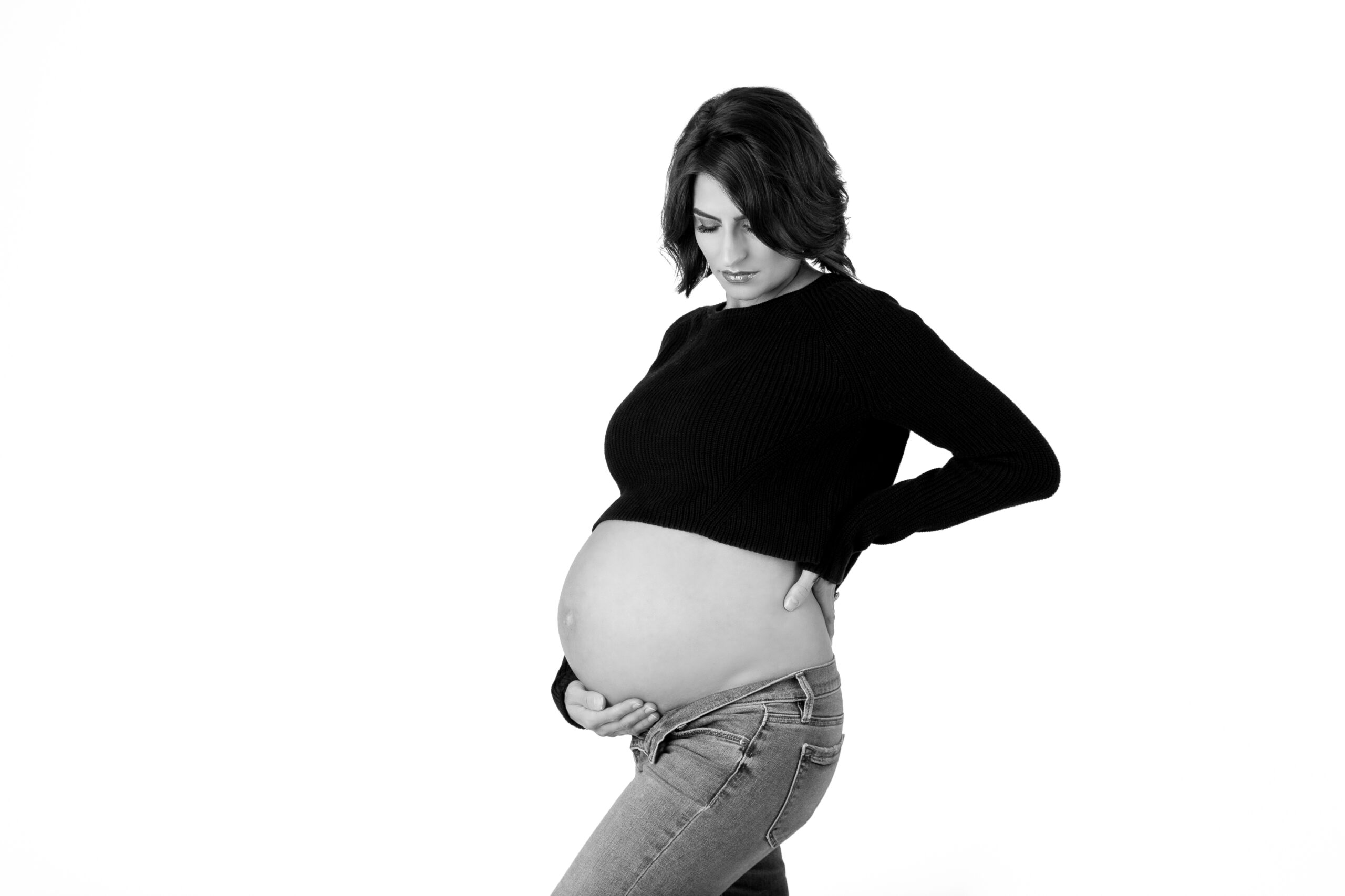 Black & white studio maternity portrait women in black sweater