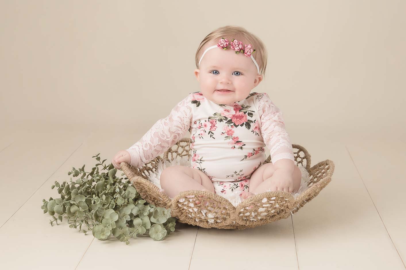 Baby girl sitting in basket