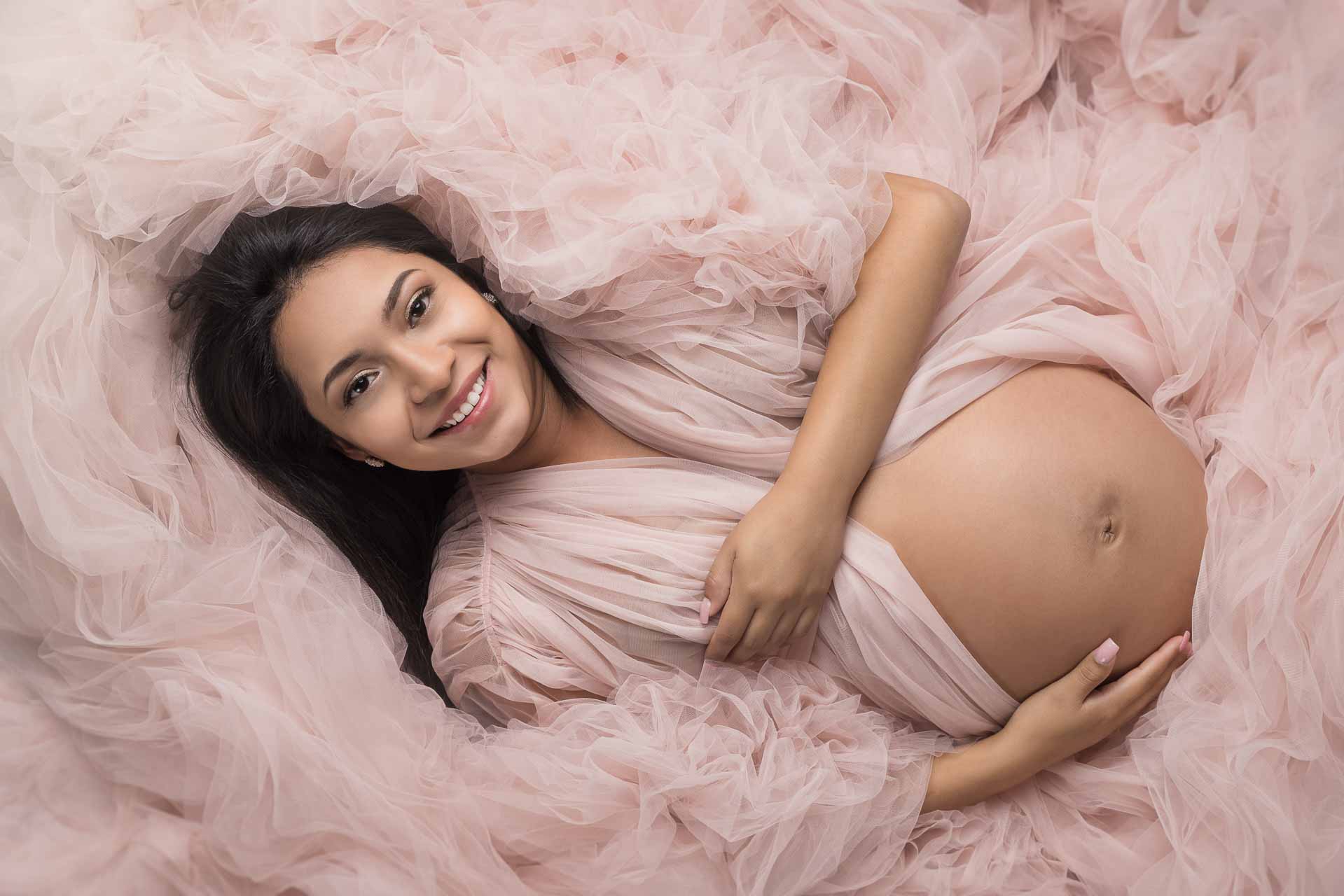 Pregnant woman in pink maternity dress
